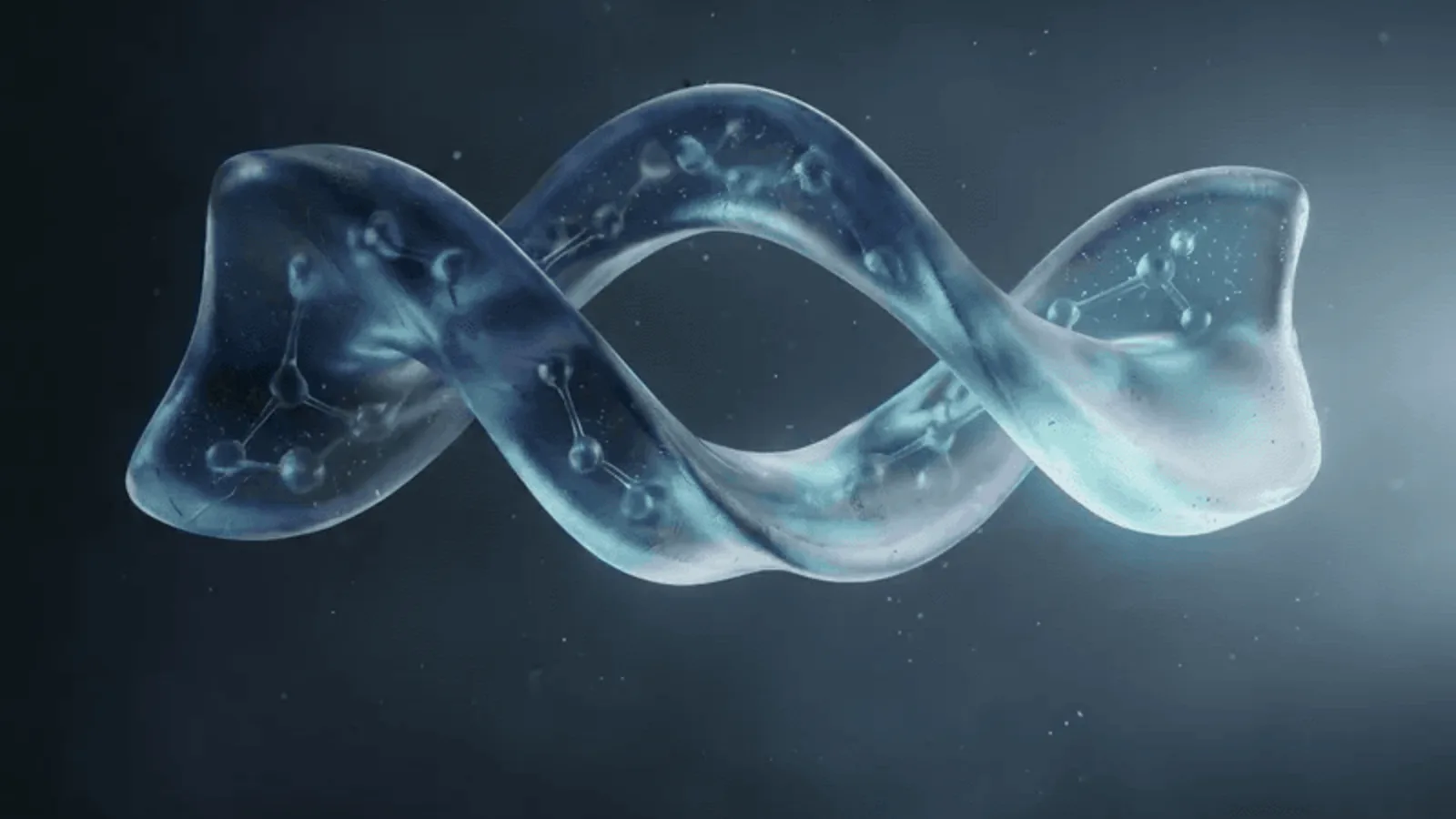 A translucent glass double helix lying horizontally against a dark blue-grey background.